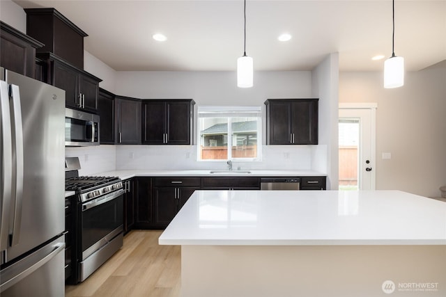128 N Trail Rd, Sedro Woolley, WA 98284 - kitchen featuring appliances with stainless steel finishes, light wood finished floors, decorative backsplash, recessed lighting, and light countertops