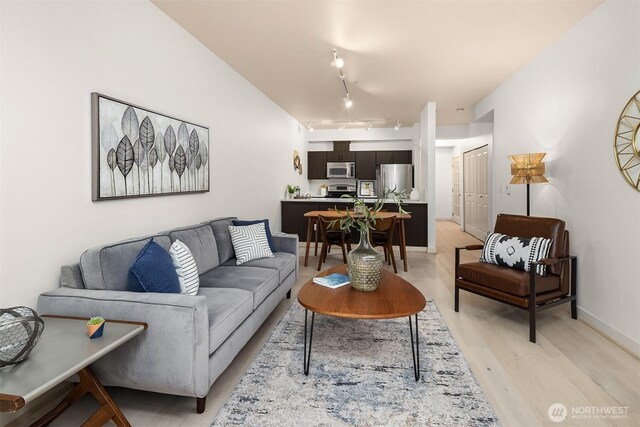 300 110th Ave NE Unit 303, Bellevue, WA 98004 - living area featuring light wood-style flooring and rail lighting