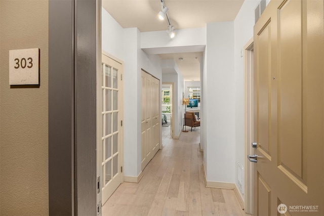 300 110th Ave NE Unit 303, Bellevue, WA 98004 - hall featuring light wood-type flooring and rail lighting