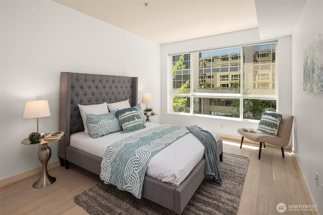 300 110th Ave NE Unit 303, Bellevue, WA 98004 - bedroom featuring wood finished floors and baseboards