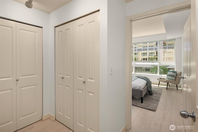 300 110th Ave NE Unit 303, Bellevue, WA 98004 - hallway featuring light wood-style flooring and baseboards