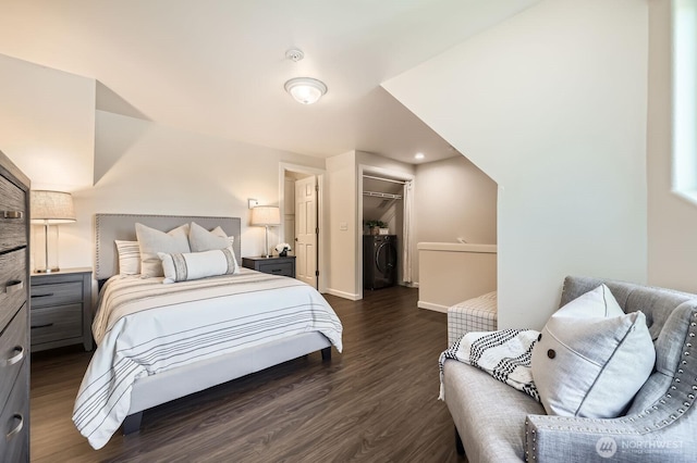 17201 127th Pl NE Unit 101, Woodinville, WA 98072 - bedroom featuring dark wood-style flooring, a spacious closet, a closet, and washer / clothes dryer