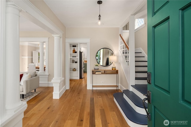 2401 10th Ave W, Seattle, WA 98119 - entrance foyer with ornate columns, stairs, and light wood-type flooring
