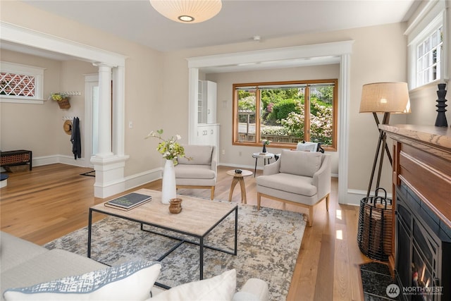 2401 10th Ave W, Seattle, WA 98119 - living area featuring decorative columns and light wood-style flooring