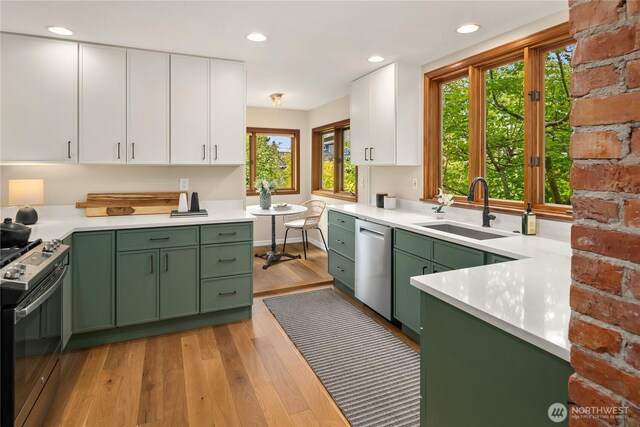2401 10th Ave W, Seattle, WA 98119 - kitchen with green cabinets, stainless steel appliances, white cabinetry, light wood-style floors, and recessed lighting