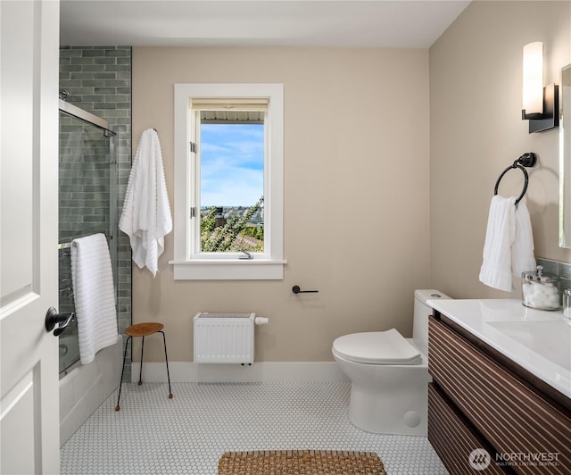 2401 10th Ave W, Seattle, WA 98119 - full bathroom featuring radiator, vanity, tile patterned flooring, and bath / shower combo with glass door
