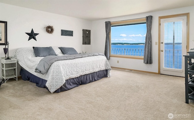 212 Tala Shore Dr, Port Ludlow, WA 98365 - carpeted bedroom with baseboards and a water view