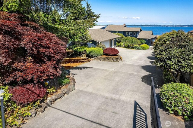 212 Tala Shore Dr, Port Ludlow, WA 98365 - exterior space with concrete driveway, a water view, and an attached garage