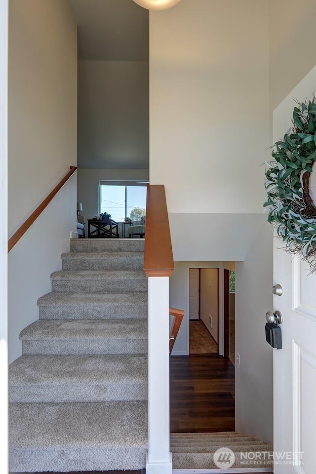 1011 S 64th St, Tacoma, WA 98408 - staircase with wood finished floors and a towering ceiling