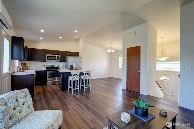 1011 S 64th St, Tacoma, WA 98408 - living area with dark wood-style flooring, a chandelier, high vaulted ceiling, and recessed lighting