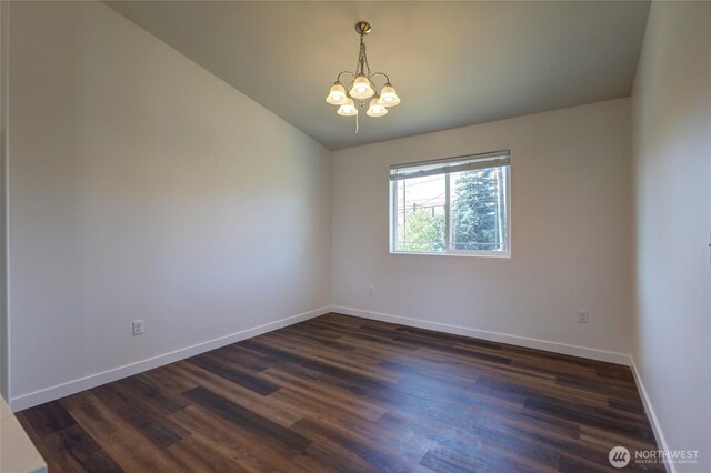 1011 S 64th St, Tacoma, WA 98408 - empty room featuring a chandelier, dark wood-type flooring, and vaulted ceiling