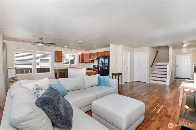 1228 81st Dr SE, Lake Stevens, WA 98258 - living area with ceiling fan, dark wood-style flooring, and stairway
