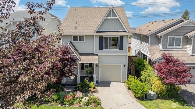 1228 81st Dr SE, Lake Stevens, WA 98258 - view of front of property with concrete driveway, a shingled roof, and a garage
