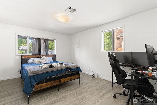 4515 14th Way SE, Lacey, WA 98503 - bedroom featuring multiple windows, light wood-style flooring, and a desk