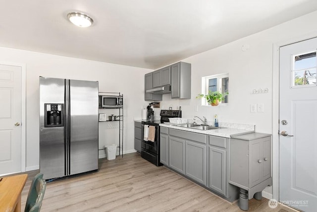 4515 14th Way SE, Lacey, WA 98503 - kitchen with appliances with stainless steel finishes, gray cabinets, light countertops, light wood-type flooring, and under cabinet range hood
