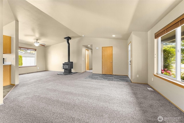 1875 Florence St, Enumclaw, WA 98022 - unfurnished living room featuring a wood stove, light colored carpet, lofted ceiling, a ceiling fan, and recessed lighting