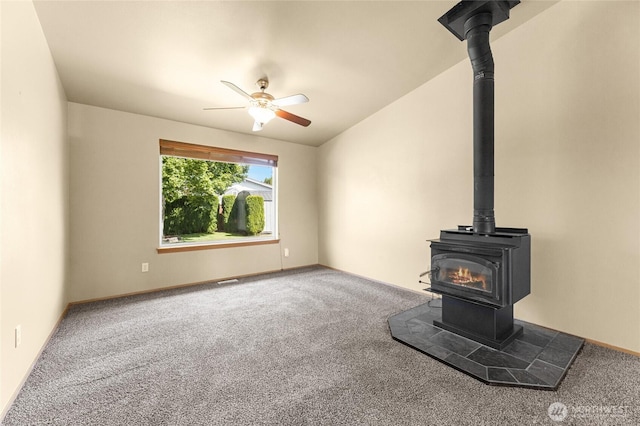 1875 Florence St, Enumclaw, WA 98022 - unfurnished living room with a wood stove, carpet flooring, and a ceiling fan