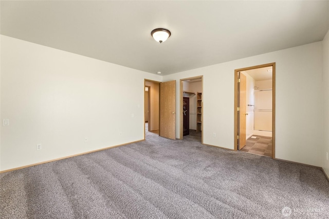 1875 Florence St, Enumclaw, WA 98022 - unfurnished bedroom featuring a walk in closet, carpet flooring, ensuite bath, and a closet