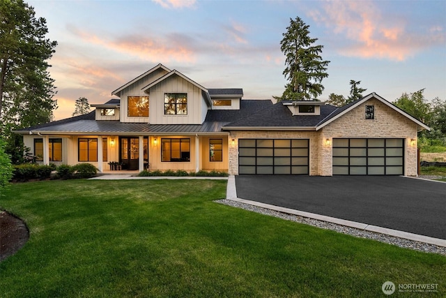 1521 8th St SW, Puyallup, WA 98371 - modern farmhouse featuring a standing seam roof, a porch, an attached garage, a front lawn, and board and batten siding