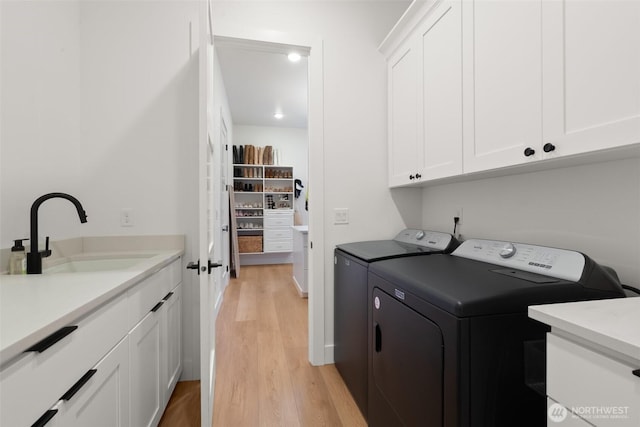 1521 8th St SW, Puyallup, WA 98371 - laundry area with washing machine and dryer, cabinet space, and light wood-style flooring
