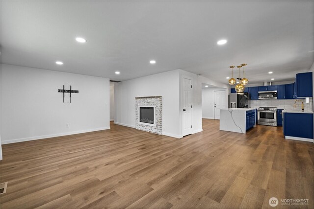 5206 68th Ave W, University Place, WA 98467 - unfurnished living room featuring recessed lighting, dark wood finished floors, and a fireplace