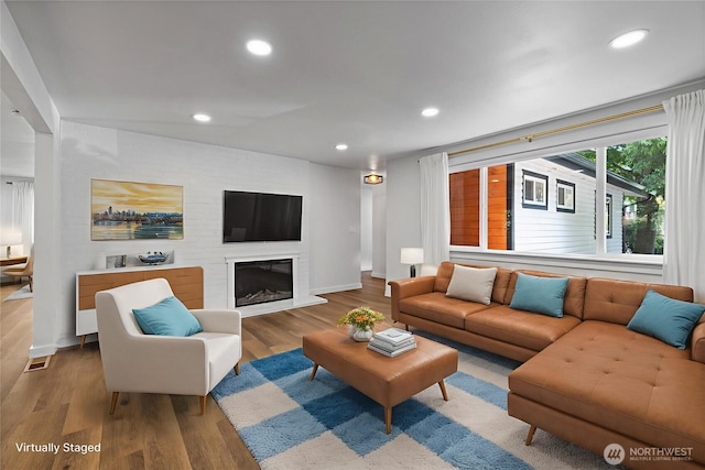 5206 68th Ave W, University Place, WA 98467 - living room featuring wood finished floors, recessed lighting, and a fireplace with raised hearth