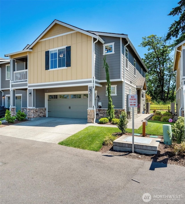 8715 E Gilman Ave, Arlington, WA 98223 - view of front of property with stone siding, a garage, driveway, and board and batten siding