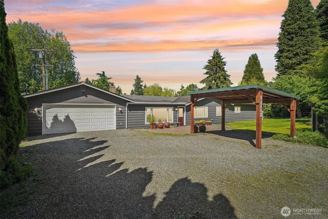 11112 E Riverside Dr, Bothell, WA 98011 - view of front facade featuring driveway, an attached garage, and a carport