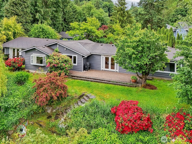 11112 E Riverside Dr, Bothell, WA 98011 - rear view of house featuring a deck, a lawn, french doors, and a shingled roof