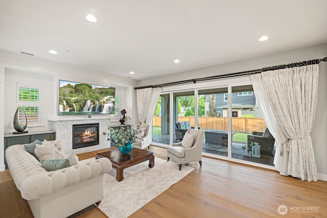 3348 218th St SE, Bothell, WA 98021 - living room featuring a premium fireplace, plenty of natural light, wood finished floors, and recessed lighting