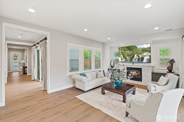 3348 218th St SE, Bothell, WA 98021 - living room featuring light wood-style floors, a high end fireplace, healthy amount of natural light, and recessed lighting
