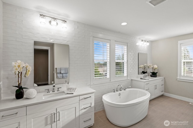 3348 218th St SE, Bothell, WA 98021 - full bathroom featuring two vanities, a soaking tub, and tile patterned floors