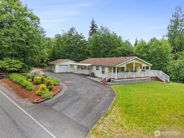 158 S Fork Rd, Raymond, WA 98577 - single story home with a porch, an outdoor structure, a detached garage, a front yard, and driveway
