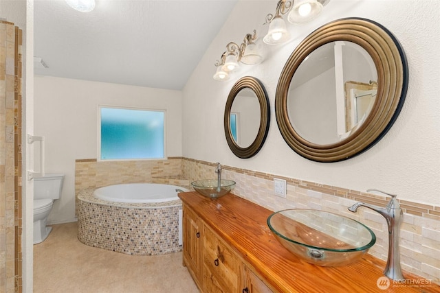 158 S Fork Rd, Raymond, WA 98577 - full bathroom featuring a bath, double vanity, and vaulted ceiling