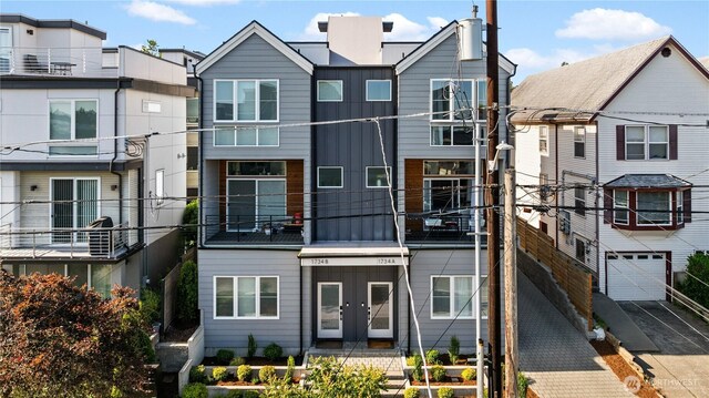 1734 NW 62nd St Unit A, Seattle, WA 98107 - view of front facade featuring french doors, a garage, and driveway