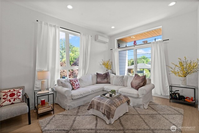 1734 NW 62nd St Unit A, Seattle, WA 98107 - living area featuring a wall mounted air conditioner, wood finished floors, and recessed lighting