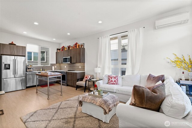 1734 NW 62nd St Unit A, Seattle, WA 98107 - living room with light wood-style floors, a wall unit AC, and recessed lighting