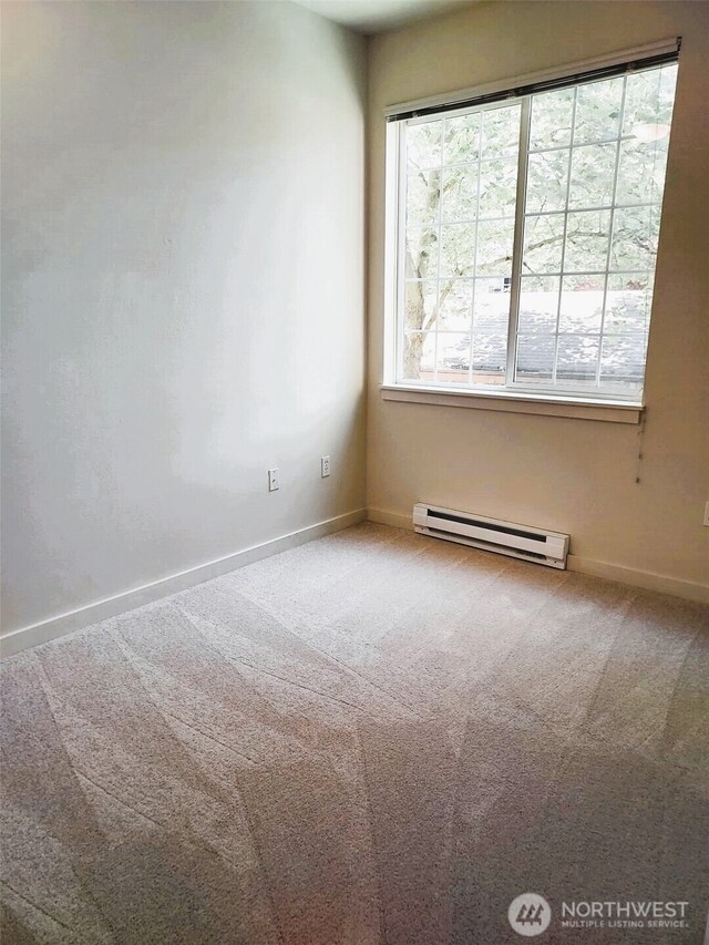 25025 SE Klahanie Blvd Unit D202, Sammamish, WA 98029 - carpeted empty room with a baseboard heating unit and baseboards