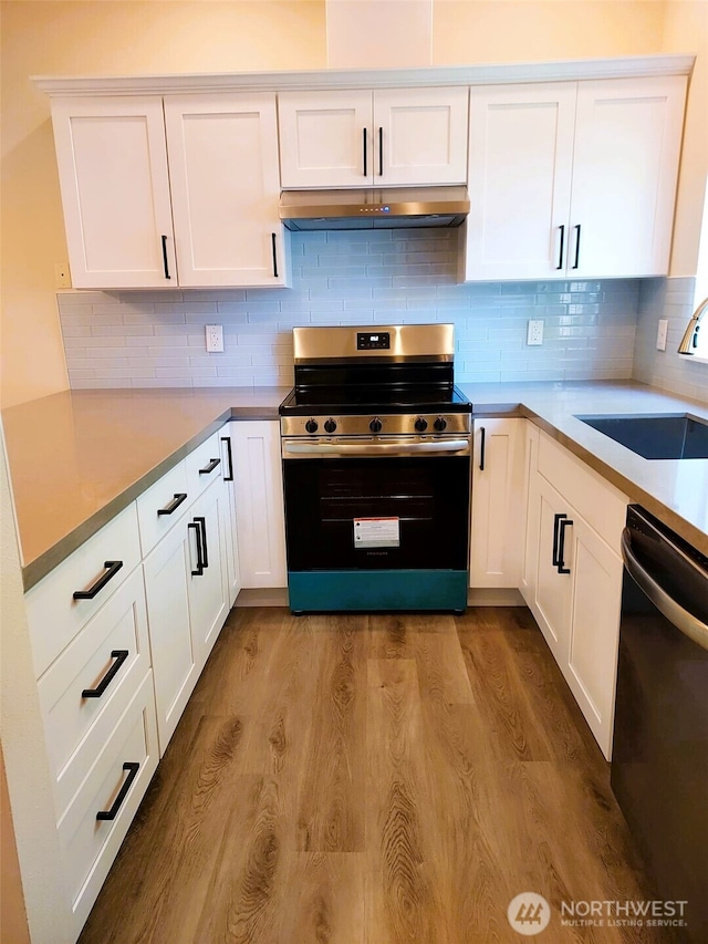25025 SE Klahanie Blvd Unit D202, Sammamish, WA 98029 - kitchen featuring electric range, dishwasher, wood finished floors, and under cabinet range hood