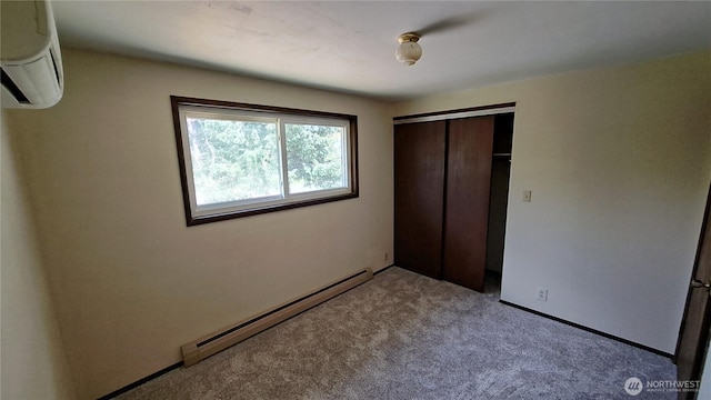 3410 Forest Ct, Bellingham, WA 98225 - unfurnished bedroom featuring baseboard heating, a wall mounted AC, a closet, and light colored carpet