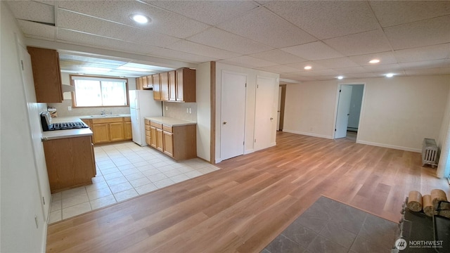 3410 Forest Ct, Bellingham, WA 98225 - kitchen with freestanding refrigerator, radiator heating unit, light wood-style floors, light countertops, and recessed lighting