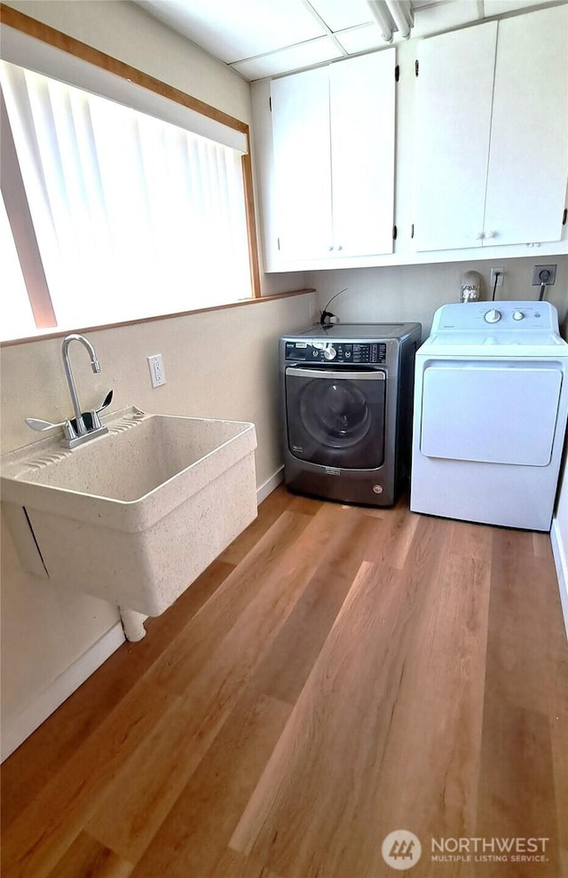 3410 Forest Ct, Bellingham, WA 98225 - laundry room with cabinet space, washer and clothes dryer, and light wood-type flooring