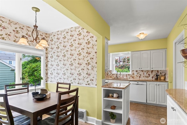 4116 N 39th St, Tacoma, WA 98407 - dining room featuring wallpapered walls, healthy amount of natural light, wainscoting, and a chandelier