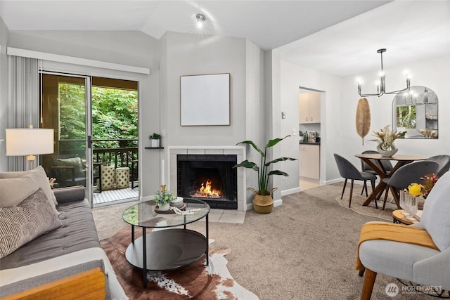 5300 Harbour Pointe Blvd Unit 311B, Mukilteo, WA 98275 - living room with light carpet, a chandelier, a fireplace with flush hearth, and lofted ceiling