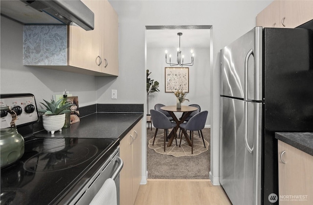 5300 Harbour Pointe Blvd Unit 311B, Mukilteo, WA 98275 - kitchen featuring appliances with stainless steel finishes, extractor fan, a chandelier, light wood-style flooring, and dark countertops