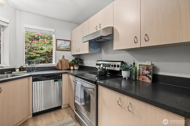 5300 Harbour Pointe Blvd Unit 311B, Mukilteo, WA 98275 - kitchen with appliances with stainless steel finishes, under cabinet range hood, light brown cabinetry, and light wood finished floors