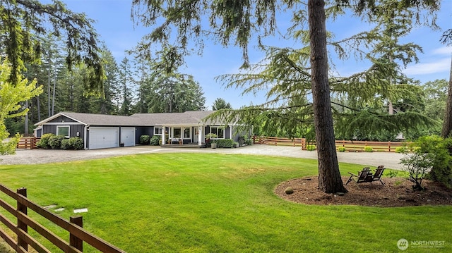 5810 246th St E, Graham, WA 98338 - ranch-style house featuring curved driveway and a garage