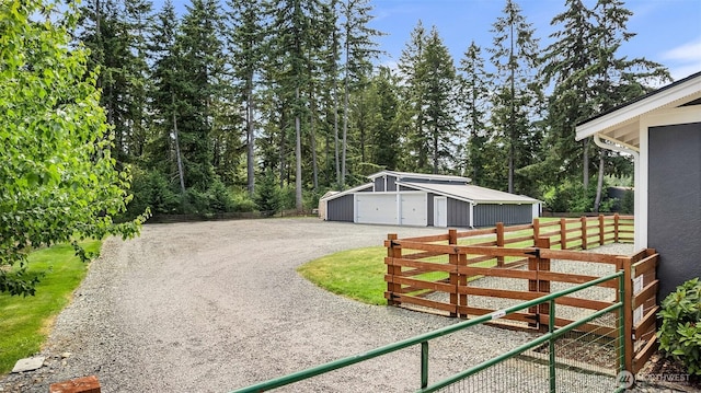 5810 246th St E, Graham, WA 98338 - view of yard featuring a detached garage, an outbuilding, and driveway