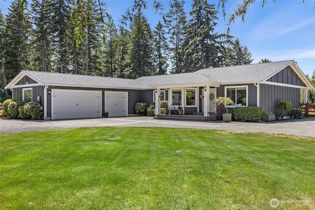 5810 246th St E, Graham, WA 98338 - single story home with board and batten siding, an attached garage, a front lawn, driveway, and a shingled roof