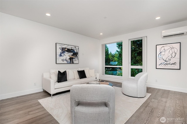 7731 NE 175th St Unit 102, Kenmore, WA 98028 - living area featuring a wall mounted air conditioner, wood finished floors, and recessed lighting